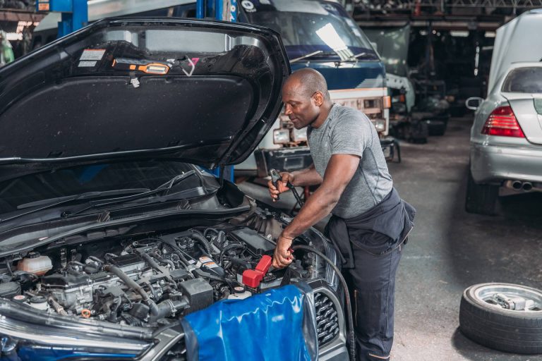 mechanic-repairing-car-engine-in-garage-workshop-2026-03-17-20-17-30-utc-1